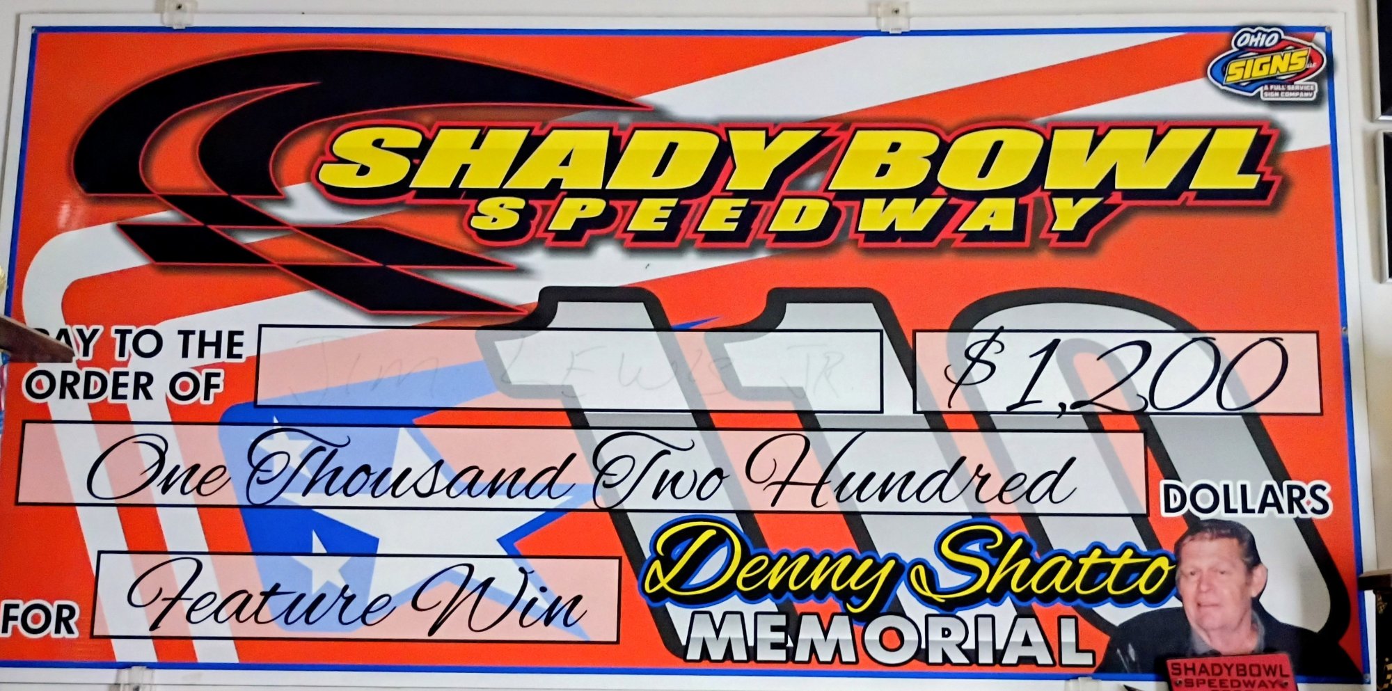 The check won by Jim Lewis Jr for first 55lap race